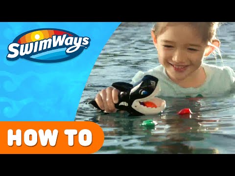 Pool game shaped like a whale whose mouth opens up. Kids try to use the whale's mouth to swallow up the little toy fish.