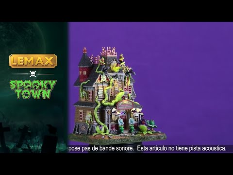 This is a video showing the Lemax Spooky Town lighted building designed to look like a dilapidated mansion that's been overtaken by man-eating plants. Some of the windows are boarded up and some of the monsters are coming out of the other windows.