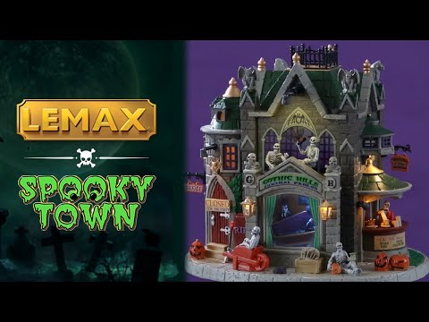 Resin lighted building for a Lemax display. Designed to look like a gothic castle. There are skeletons and skull accents, as well as gargoyles, pumpkins and rats. Inside the window you can see a skeleton testing out a coffin. Over to the right, there's a bar with a skeleton ready to serve you.