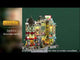 Resin building facade for a Lemax display. Designed to look like a bunch of store fronts. Signs read: "Fay's Flowers & Bouquets," "The Burger Cafe," "Jolly Toys & Games," "Quilter's Island," Sweet Spot" and "Hot Fresh Coffee at the Christmas Bazaar!" There are flowers everywhere and a billboard on the roof advertising a visit with Santa.