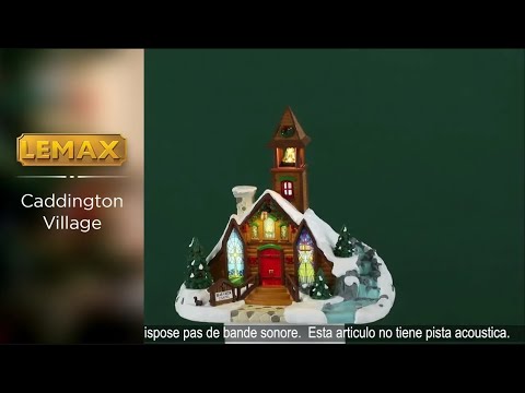 Resin lighted building for a Lemax display. Designed to look like a brown, wooden chapel with a stone chimney and a bell tower. The roof and the ground is covered in snow. There's a wreath on the bell tower, garland on the roof and two red bows on the sides of the door. The windows are stained glass. One of them is a yellow cross with a blue background. The other is a white dove with a yellow glow. There's a waterfall on the side.