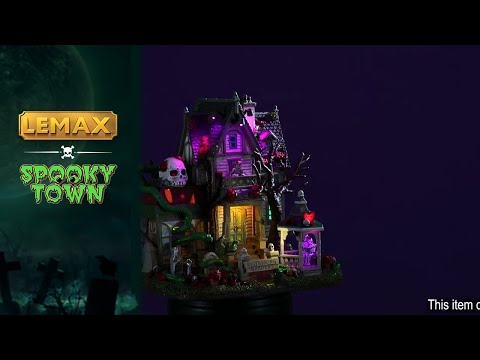 Resin lighted building for a Lemax display. Designed to look like a semi-rundown mansion. There are snakes everywhere and a large sugar skull statue on the roof. There's a gazebo with a skeleton couple hugging inside. There are flowers and skulls and tombstones and a skeleton standing on the balcony.
