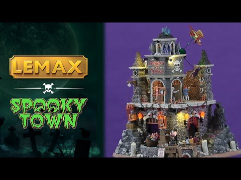 Resin lighted building for a Spooky Town display. Designed to look like a tall dungeon built into a stone mountain. There are dragons flying around the roof, a Grim Reaper off to the site and skeletons in cages. There's a ride that goes through the dungeon and there are kids in the carts.
