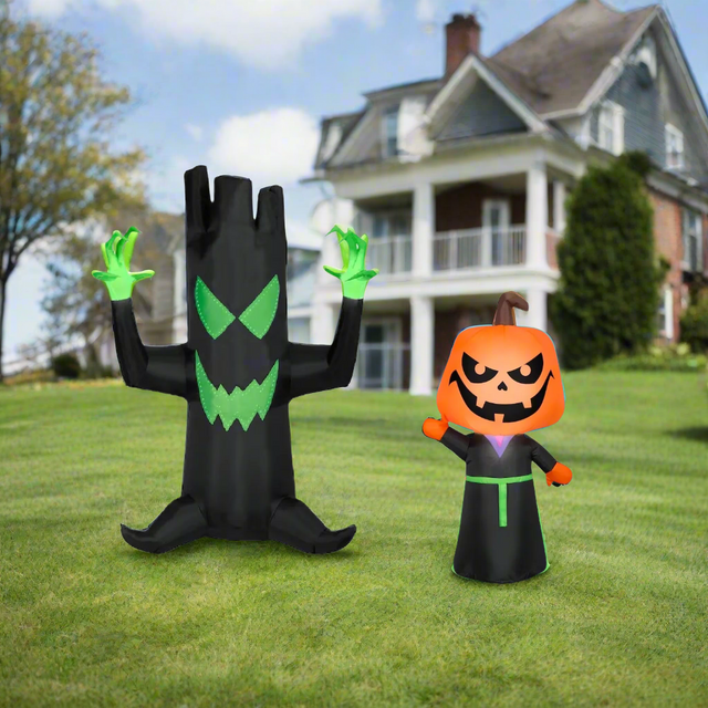 This image shows the two inflatables that come in this combo pack. They're standing on a grassy hill with a house in the background.
