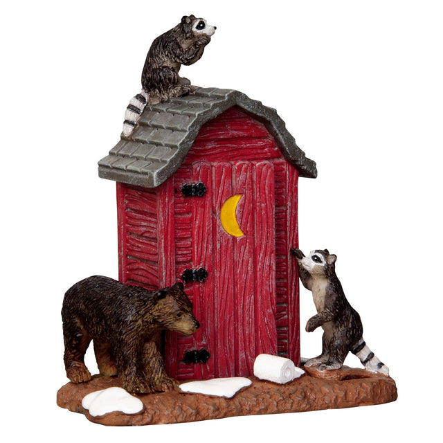 Polyresin figurine for a Lemax display. Designed to look like a red, wooden outhouse. There's a raccoon on the roof and a raccoon standing on the ground next to a roll of toilet paper. There's also a bear trying to break in. 