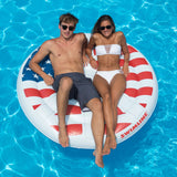 A pool float designed to look like a peace sign made out of the American flag.