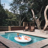 A pool float designed to look like a peace sign made out of the American flag.
