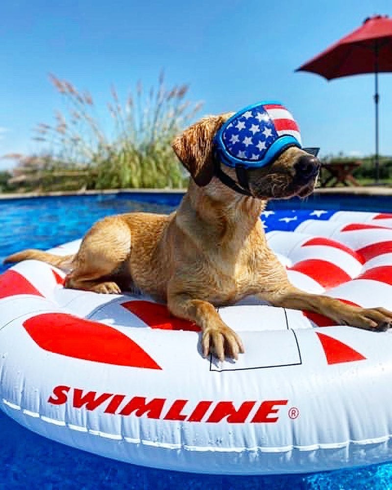A pool float designed to look like a peace sign made out of the American flag.