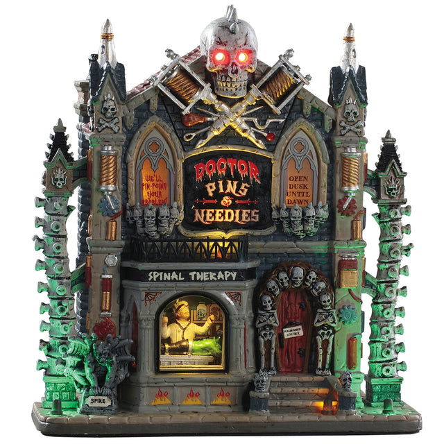 Porcelain lighted building for a Lemax display. Designed to look like a Victorian-era building with a skull statue on the roof and columns made out of spines. Inside the window you can see the doctor examining a monster.