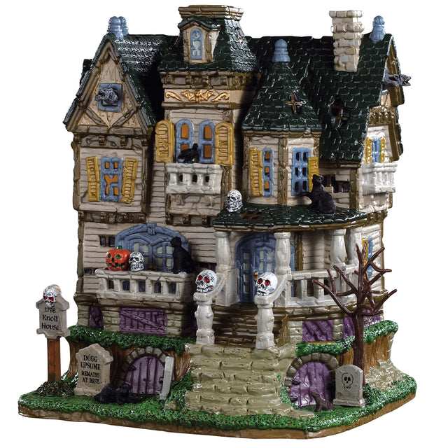 Porcelain house for a Lemax display. Designed to look like a tall, old mansion accented with tombstones, skulls, crows, rats and trees with no leaves.