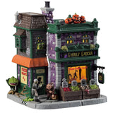 Porcelain lighted building for a Lemax display. Designed to look like a brick grocery store. There are monsters at the front door and boxes of stuff you can buy near the front window. Inside the window, you can see some creepy crawlies hanging from hooks. There are carved pumpkins on the roof.