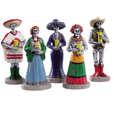 Polyresin figurines for a Lemax display. Designed to look like five skeletons dressed for a Dia De Los Muertos vigil and holding yellow candles.