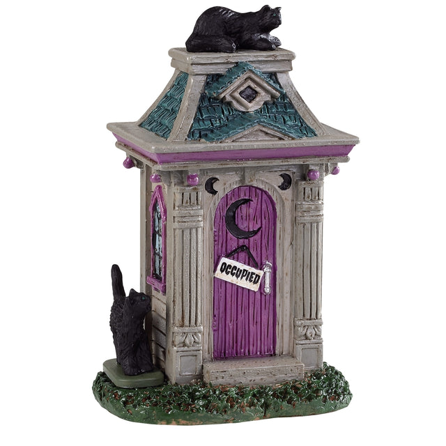 Polyresin figure for a Lemax display. Designed to look like a purple, gray and teal outhouse. There's a black cat on the roof and a black cat on the side. There's a sign on the door that reads "OCCUPIED."