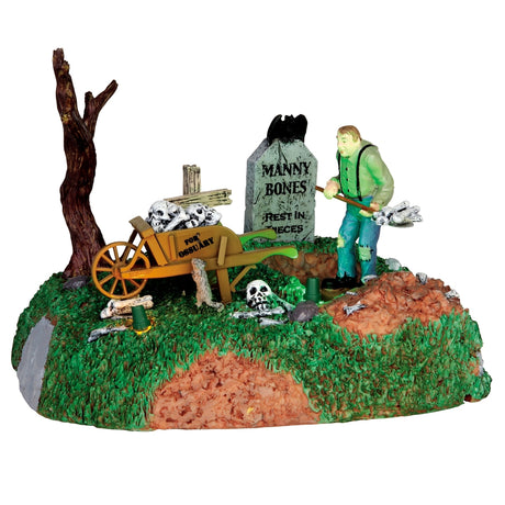 Plastic village accent for a Lemax display. Designed to look like a monster digging a grave. There are bones everywhere and a wooden wagon.