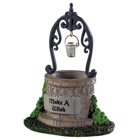 Polyresin well that appears to be made of stone. The sign reads "Make a Wish." There's grass and leaves on each side