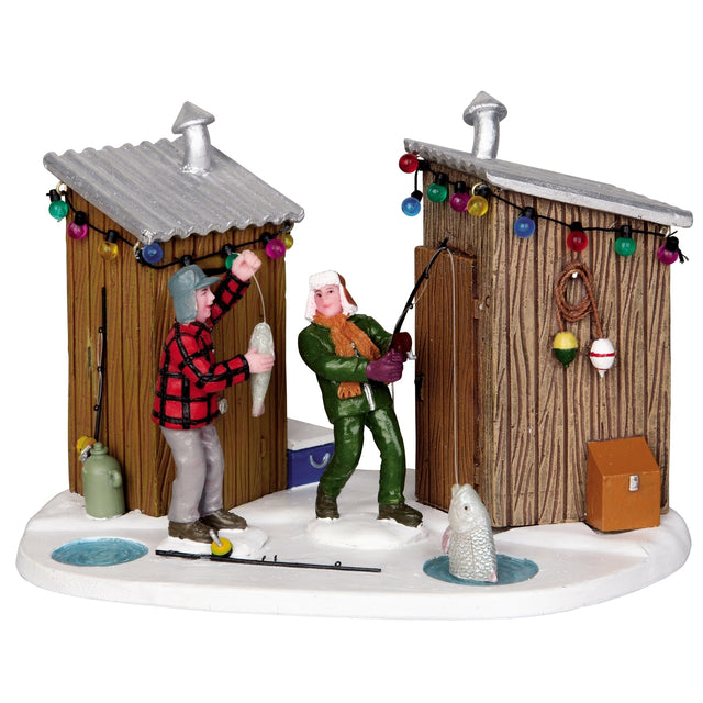 Polyresin village accent for a Lemax display. Designed to look like two people ice fishing in between two small wooden huts. There are multi-colored lights hanging from the roof.