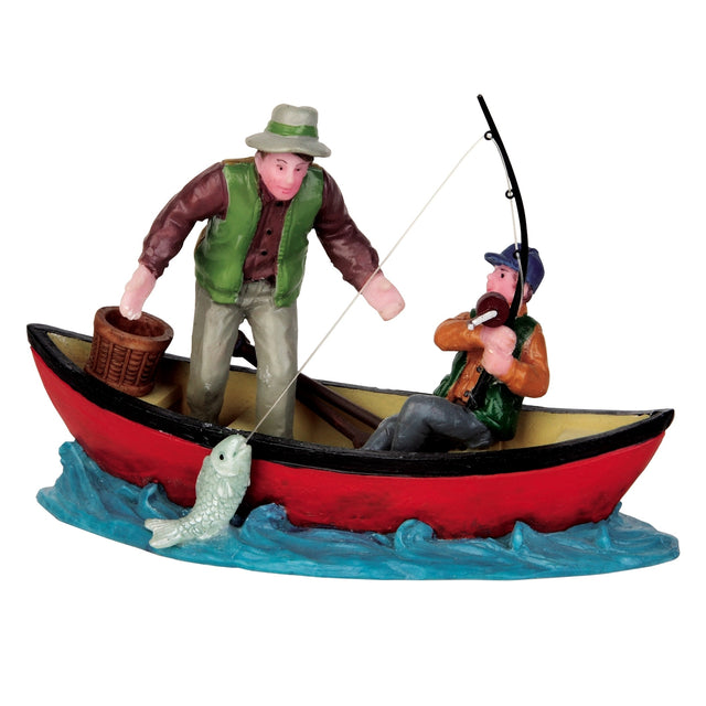Polyresin figurine for a Lemax display. Designed to look like a father and son in a red boat, fishing. The young boy has a large fish at the end of his fishing rod and the dad looks surprised.