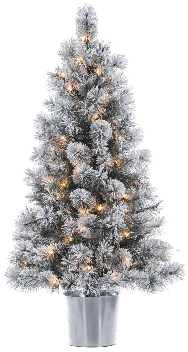 White potted artificial tree pre-lit with warm white lights. It's in a silver base.