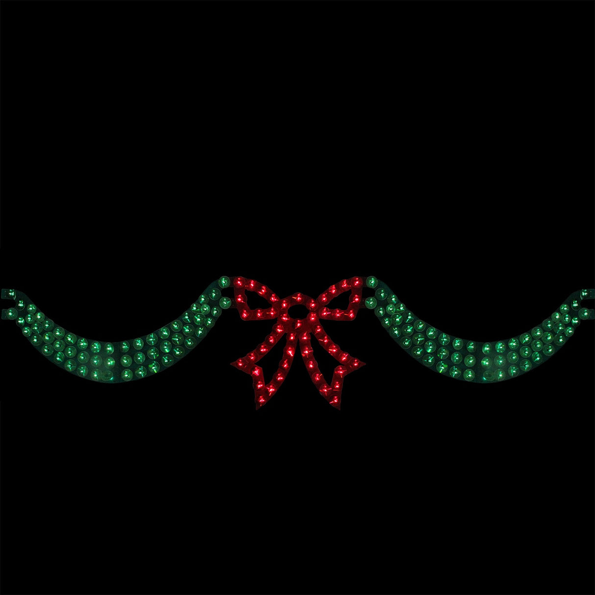 6 foot long lighted Christmas decoration designed to look like green ribbon with a red bow in the center. The background is black so you can see what it would look like at night.