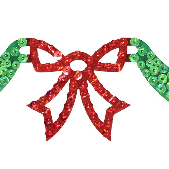 An up close view of the 6 foot long lighted Christmas decoration designed to look like green ribbon with a red bow in the center.