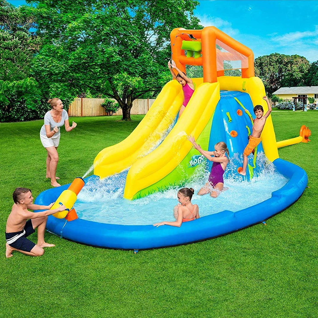 Massive inflatable backyard water park for kids. There's a small water slide that lands into a small pool and there's a fun wall to climb.