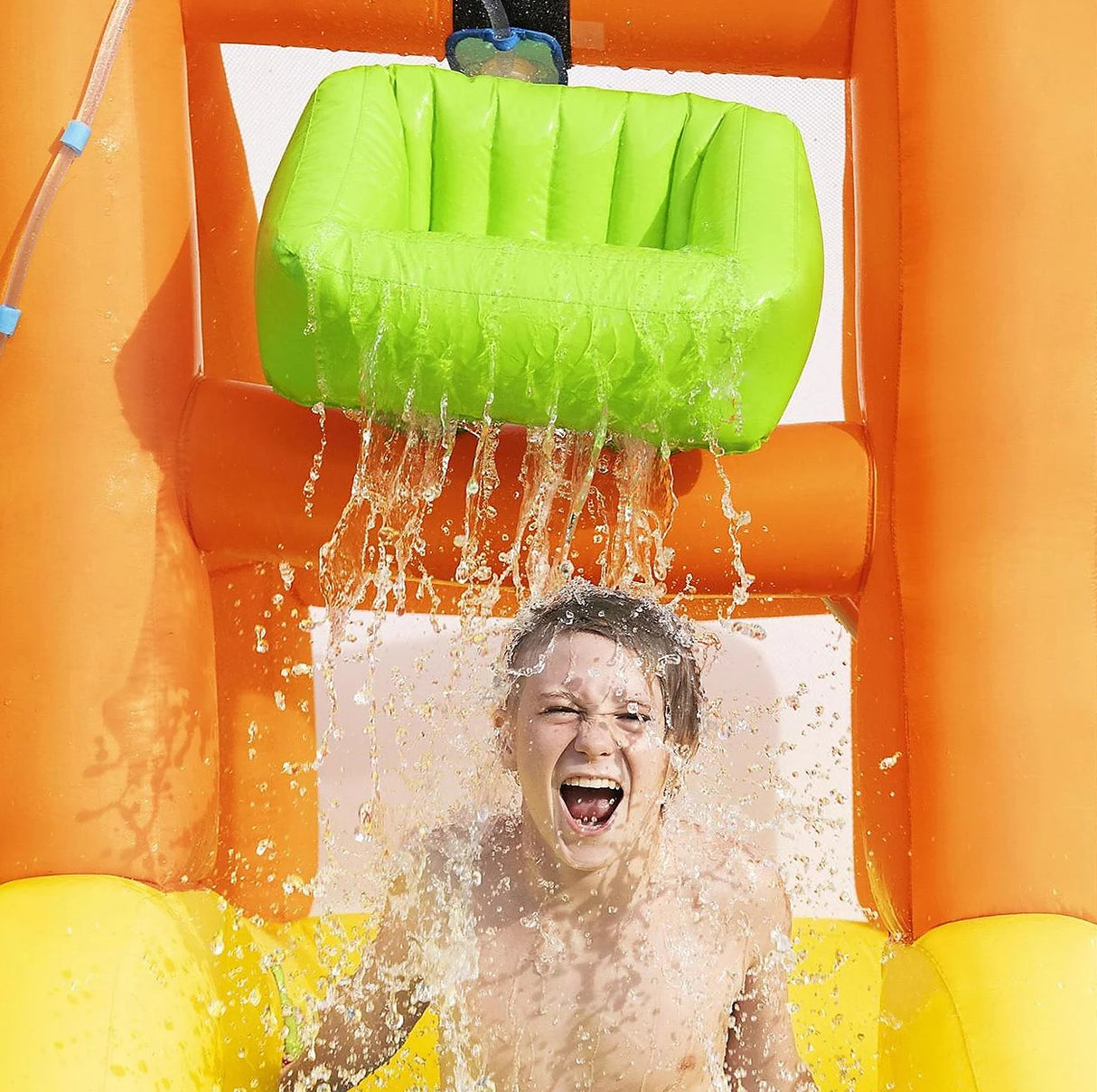 Massive inflatable backyard water park for kids. There's a small water slide that lands into a small pool and there's a fun wall to climb.
