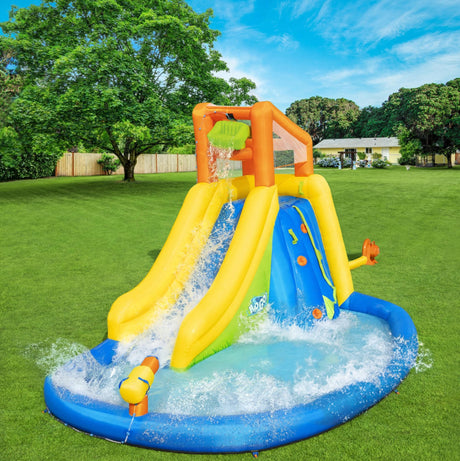 Massive inflatable backyard water park for kids. There's a small water slide that lands into a small pool and there's a fun wall to climb.