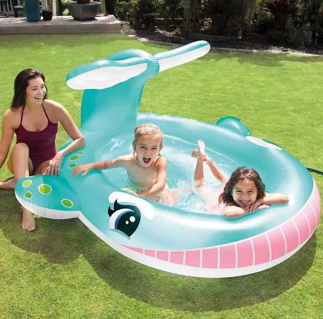 Inflatable pool for kids shaped like a cute, blue whale.