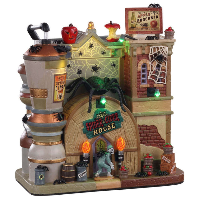 Porcelain lighted building for a Lemax display. Designed to look like a large, brick brewery. There's a full apple statue and a half eaten apple statue on the roof. There are spiderwebs and spiders everywhere. There's a large spider on the roof. There's a skeleton walking in the front door.