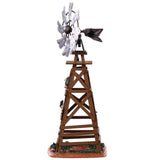 Polyresin table accent for a Lemax display. Designed to look like a wooden windmill with metal blades. There are two signs on it that read "DANGER!" and "BEWARE OF FALLING BLADES!" The danger sign has a small owl sitting on it. The beware sign has a big, black spider on it. There's a little bit of grass and dirt on the ground underneath it. There's a small rat standing at the bottom.