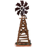 Polyresin table accent for a Lemax display. Designed to look like a wooden windmill with metal blades. There are two signs on it that read "DANGER!" and "BEWARE OF FALLING BLADES!" The danger sign has a small owl sitting on it. The beware sign has a big, black spider on it. There's a little bit of grass and dirt on the ground underneath it. There's a small rat standing at the bottom.