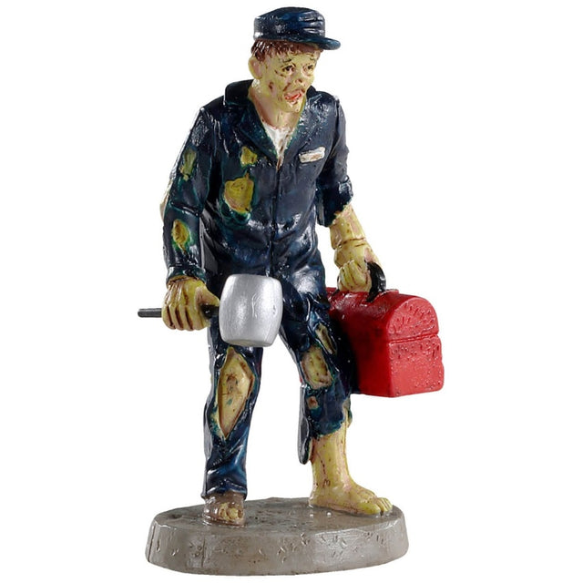 Polyresin figurine for a Lemax Spooky Town display. Designed to look like a monster mechanic. He's holding a hammer and a red tool box. He's wearing a blue cap and blue, torn up coveralls. He's barefoot.