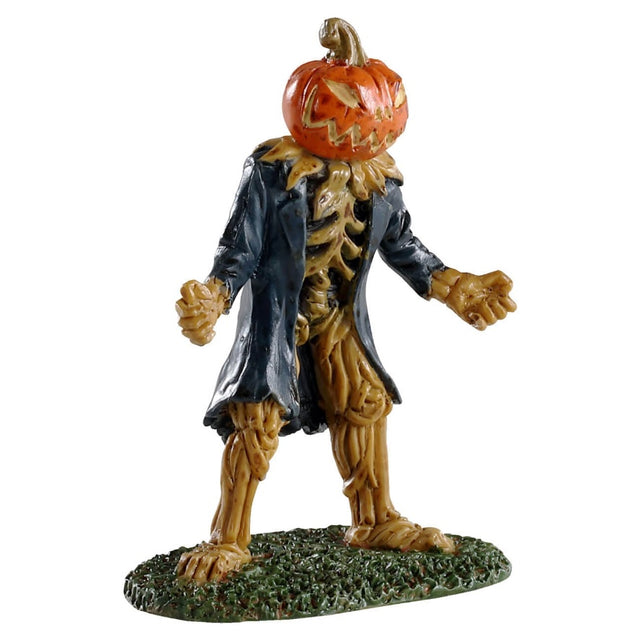 Polyresin figurine for a Lemax Spooky Town display. Designed to look like a pumpkin monster. It looks like the guts of the pumpkin have formed a skeleton and the pumpkin is the head. It's carved into a spooky smile. He's wearing a long blue jacket and standing on grass.