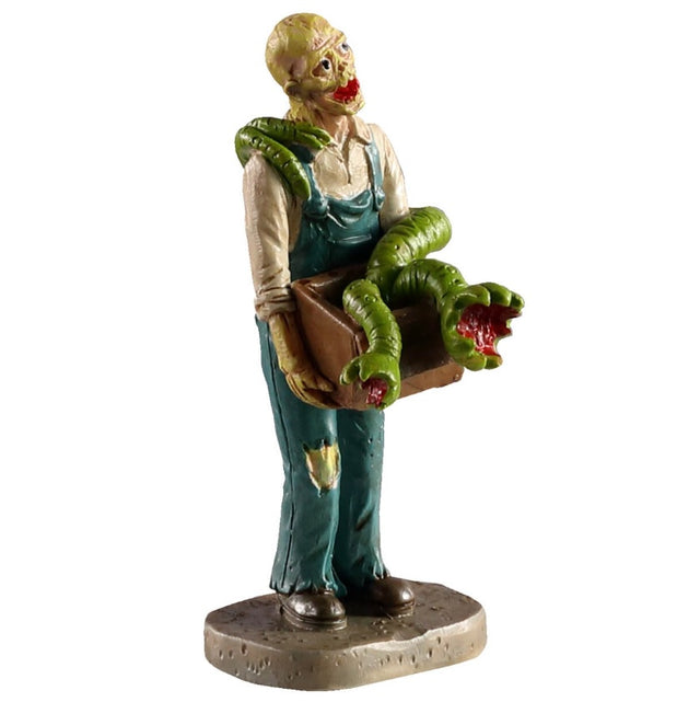Polyresin figurine for a Lemax Spooky Town display. Designed to look like a spooky skeleton wearing overalls. He's holding a box of scary plants.