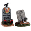 Polyresin village accents for a Lemax Spooky Town display. Designed to look like two worn down tombstones. One tombstones has a creepy, smiling clown on it and it reads "CREEPY THE CLOWN. HE DIED LAUGHING. DON'T LAUGH - YOU'LL BE NEXT" and has two red clown shoes peeking out. One tombstone reads "RAY N CARNATION. I'LL BE BACK! YOU CAN'T KEEP A GOOD MAN DOWN" and has a skeleton coming out of the grave.