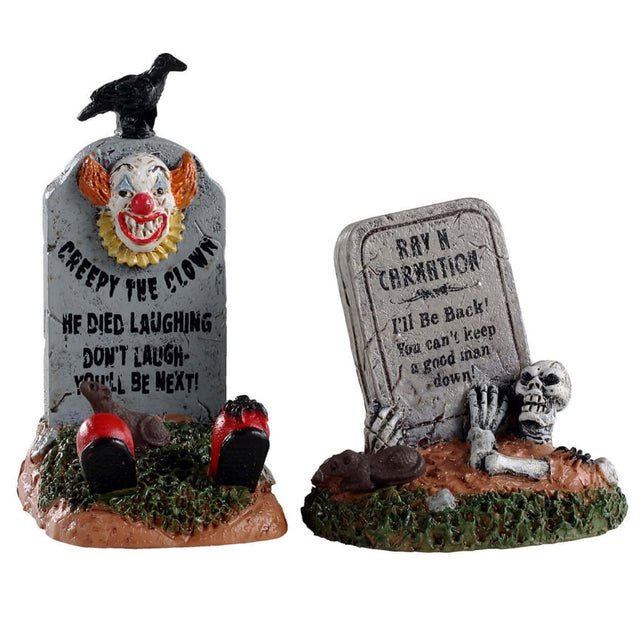 Polyresin village accents for a Lemax Spooky Town display. Designed to look like two worn down tombstones. One tombstones has a creepy, smiling clown on it and it reads "CREEPY THE CLOWN. HE DIED LAUGHING. DON'T LAUGH - YOU'LL BE NEXT" and has two red clown shoes peeking out. One tombstone reads "RAY N CARNATION. I'LL BE BACK! YOU CAN'T KEEP A GOOD MAN DOWN" and has a skeleton coming out of the grave.