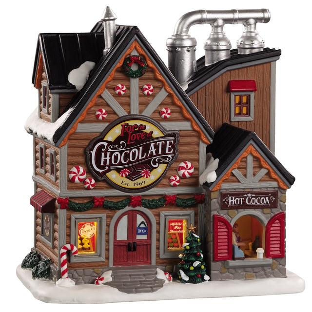 Porcelain lighted building for a Lemax Village tabletop display. Designed to look like a very large chocolate shop covered in peppermint candies and decorated for Christmas