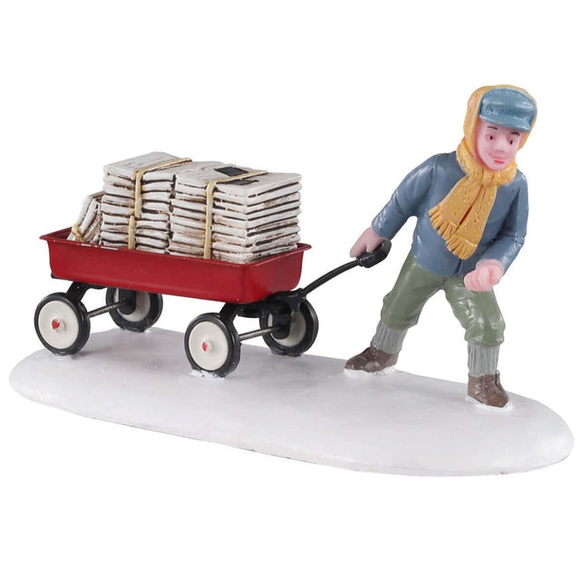 Polyresin figurine for a Lemax Village tabletop display. Designed to look like a young boy pulling a red wagon full of newspapers