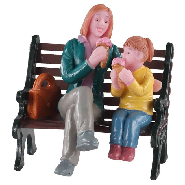 Polyresin figurine for a Lemax display. Designed to look like a mom and young daughter eating ice cream on a wooden bench.