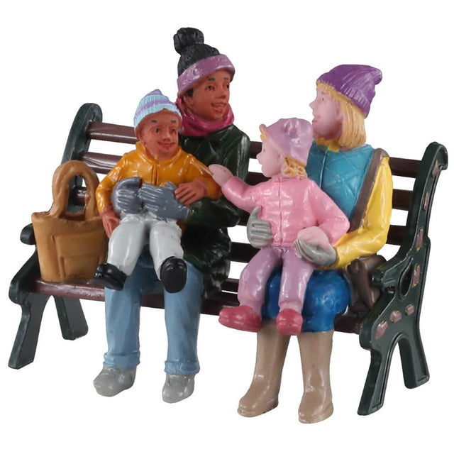 Polyresin figurine for a Lemax Village tabletop display. Designed to look like two women holding their kids on a wooden bench. They're wearing heavy winter clothes