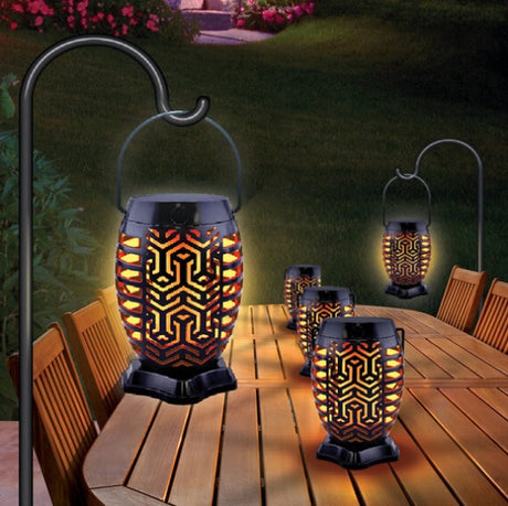 This is a lifestyle image showing two lanterns hanging and three lanterns in the center of a table.