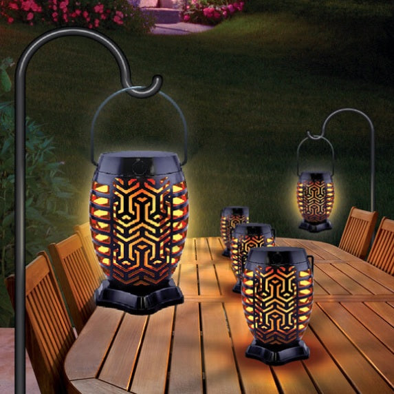 This is a lifestyle image showing two lanterns hanging and three lanterns in the center of a table.