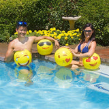 Yellow beach balls designed to look like different emojis.
