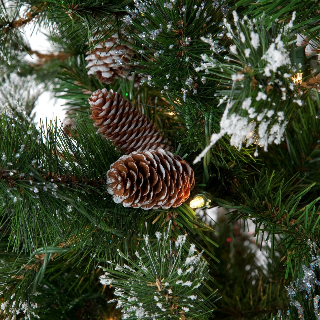 Artificial tree with white glitter on the branches. Pre-lit with clear lights.