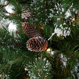 Artificial tree with white glitter on the branches. Pre-lit with clear lights.