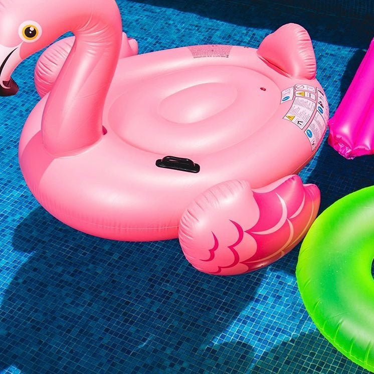 Pool float shaped like a large, pink flamingo.