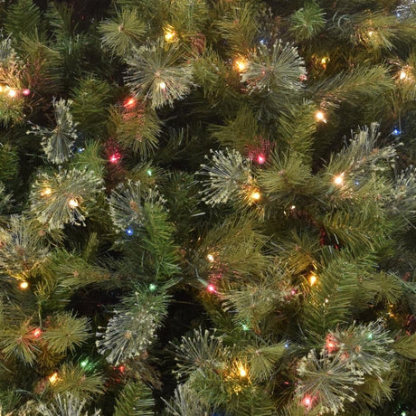 Artificial tree pre-lit with multi-colored lights.