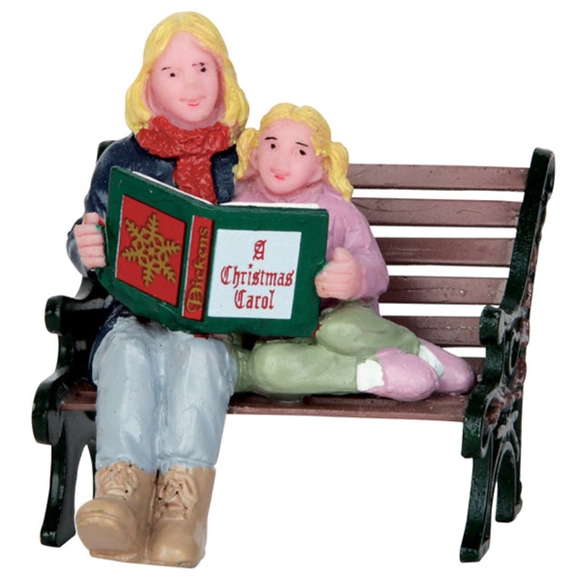 Polyresin figurine for a Lemax display. Designed to look like a mom reading A Christmas Carol to her young daughter on a wooden bench. They're both wearing winter clothes.