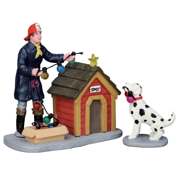 Polyresin figurines for a Lemax display. Designed to look like a young boy and a Dalmatian decorating a dog house for Christmas. They're putting multi-colored lights on the roof.
