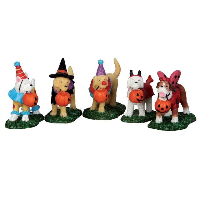 Polyresin figurines for a Lemax display. Designed to look like five dogs wearing costumes. Two dogs are dressed like clowns, one is dressed like a witch, one is dressed like the devil and the last dog is dressed like a butterfly. They all have pumpkin shaped candy buckets in their mouths.